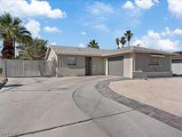 Single story home featuring a circular driveway, mature landscaping, and a two-car garage at 4204 El Jardin Ave, Las Vegas, NV 89102