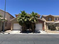 Charming two-story home featuring a two-car garage, palm trees, and a well-maintained front yard at 5419 Brass Hills Ct, Las Vegas, NV 89122