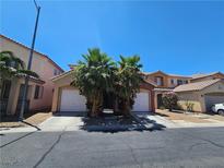 Inviting two-story home featuring a two-car garage and mature palm trees in a well maintained neighborhood at 5419 Brass Hills Ct, Las Vegas, NV 89122