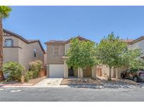 Charming home featuring desert landscaping, a two-car garage, and neutral-toned exterior at 589 Brinkburn Point Ave, Las Vegas, NV 89178