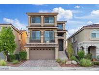 Charming three-story home showcasing a private balcony, low-maintenance landscaping, and a two-car garage at 6056 Atlantis Dream Ave, Las Vegas, NV 89139