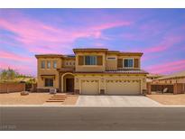 Two-story home featuring a tile roof, three car garage, neutral stucco, and a welcoming entry with stone accents at 6351 Abacus Farms Ct, Las Vegas, NV 89131