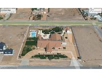 Expansive aerial view of a private estate featuring a pool, lush greenery, and a well-manicured circular driveway at 640 Quail Covey Rd, Henderson, NV 89002