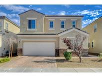 Charming two-story home featuring a brick driveway, a two-car garage, and a neatly landscaped front yard at 8531 W Oquendo Rd, Las Vegas, NV 89113