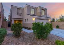 Attractive exterior view of home featuring a two-car garage, landscaped yard, and neutral color palette at 9006 Cedar Door Ave, Las Vegas, NV 89148
