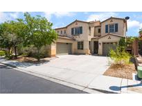 Two-story home with a desert landscape, two car garage, and a large driveway at 9319 White Waterfall Ave, Las Vegas, NV 89149