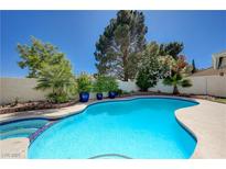 Inviting backyard pool surrounded by lush landscaping and mature trees provides a tranquil outdoor retreat at 9333 Dry Dock Dr, Las Vegas, NV 89117