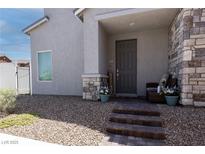 Charming front entrance with stone accents, neat gravel landscaping, and a welcoming porch seating area at 226 Callen Falls Ave # 1311, Henderson, NV 89011