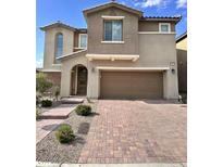Two-story home with a brick driveway and an attached two-car garage at 3114 Molinos Dr, Las Vegas, NV 89141