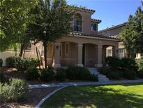 Charming two-story home featuring a covered porch, landscaped yard, and well-maintained front lawn at 3175 Obscured Light Walk, Henderson, NV 89044