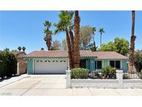 Charming single-story home with a two-car garage, tile roof, mature landscaping, and appealing curb appeal at 349 Esquina Dr, Henderson, NV 89014