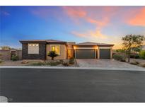 Charming single-story home with desert landscaping and a two-car garage at sunset at 4317 Velvet Ridge Ct, Las Vegas, NV 89129