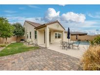 Well-maintained backyard featuring a pool, patio, and lush lawn, ideal for outdoor enjoyment at 489 Intonation St, Henderson, NV 89011
