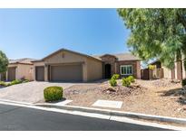 Charming single-story home with a three-car garage and well-maintained desert landscaping at 6085 Ryan Ranch Ave, Las Vegas, NV 89130