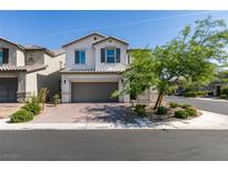 Charming two-story home with a well-manicured front yard and a brick-paved driveway at 6442 Kobe Knoll Ct, Las Vegas, NV 89141
