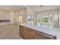 Bright, modern kitchen featuring a large island, sleek countertops, and stainless steel appliances at 10421 Linfield Pl, Las Vegas, NV 89134
