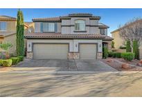 Two-story home featuring a three car garage, neutral stucco and stone accents plus well maintained landscaping at 11417 Rock Cove Way, Las Vegas, NV 89141