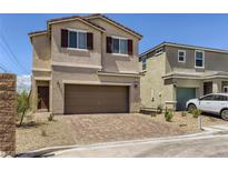 Inviting two-story home with a spacious two-car garage and desert landscaping at 1611 Prairie Fields Ct, Las Vegas, NV 89115