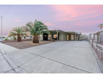 Charming single-story home boasts a spacious driveway, desert landscaping and an attached carport at 1628 Izabella Ave, Las Vegas, NV 89169