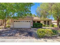 Charming single-story home featuring a well-maintained front yard and brick-paved driveway at 2026 Poppywood Ave, Henderson, NV 89012