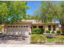 Charming single-story home featuring a well-manicured front yard and an attached two-car garage at 2026 Poppywood Ave, Henderson, NV 89012