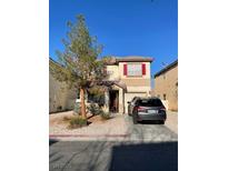 Charming two-story home featuring red shutters, a well-kept lawn, and a private driveway on a sunny day at 2190 Clancy St, Las Vegas, NV 89156