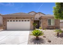 Charming single-story home featuring a well-manicured desert landscape and a spacious two-car garage at 2331 Galilean Moon St, Henderson, NV 89044