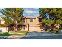 Charming two-story home with a well-manicured lawn, mature trees, and a two-car garage at 268 Copper Glow Ct, Henderson, NV 89074