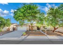 Charming single-story home with mature trees, a two-car garage, and a well-maintained front yard at 4637 Balfour Dr, Las Vegas, NV 89121