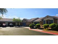 Charming single-story home featuring a tile roof, well-maintained landscaping, and convenient front-facing two-car garage at 5045 Bayberry Crest St, North Las Vegas, NV 89031