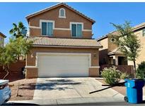 Two-story home featuring a two-car garage, neutral stucco siding, and a well-maintained front yard at 5216 Loma Verde Ave, Las Vegas, NV 89108