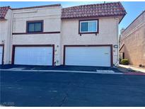 Townhome with white garage doors, a red tile roof and a stucco exterior at 5474 S Maryland Pkwy, Las Vegas, NV 89119