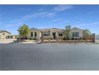 Charming single-story home featuring a desert-landscaped front yard, wrought iron fence, and a tile roof at 5812 Shangri La Night Ct, Las Vegas, NV 89149