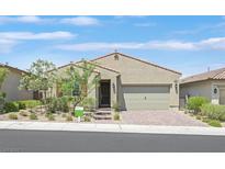 Charming single story home with a desert landscaped front yard and a brick paved driveway at 701 Webber Park St, Henderson, NV 89011