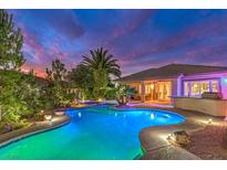 Inviting pool and outdoor kitchen area with lush landscaping, perfect for relaxing and entertaining at twilight at 8633 Kennedy Heights Ct, Las Vegas, NV 89131