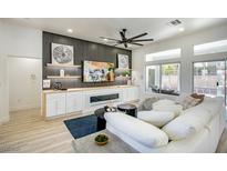 Bright living room features recessed lighting, modern ceiling fan and sleek fireplace with built-in shelving at 9813 Folsom Dr, Las Vegas, NV 89134