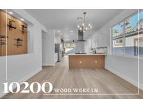 Bright living room featuring a wine rack, open floorplan, and modern chandelier at 10200 Wood Work Ln, Las Vegas, NV 89135