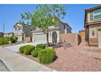 Charming home with a well-manicured front yard and mature landscaping at 1037 Water Cove St, Henderson, NV 89011