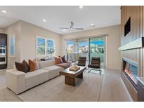 Bright living room features a fireplace, sliding glass doors, modern furniture, and neutral tones at 120 Los Cabos Dr # 301, Las Vegas, NV 89144
