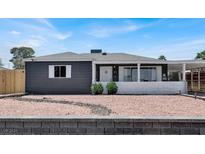 Charming single-story home featuring a gray exterior, white trim, and low-maintenance landscaping at 21 Laswell St, Henderson, NV 89015