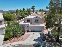 Charming two-story home boasts desert landscaping, and a well-maintained yard and driveway at 2500 Cortina Ave, Henderson, NV 89074
