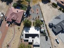 Aerial view of property showcasing a house with solar panels, landscaping, pool, and additional parking at 3031 Pebble Beach Ave, Pahrump, NV 89048