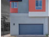 Modern home featuring a gray garage door and red siding accents at 4333 Tabor Peak Ave, Las Vegas, NV 89141