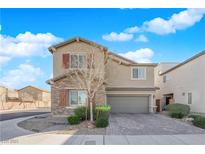 Two-story home featuring stone accents, neutral stucco, well-kept landscaping, and a gray two car garage door at 7707 W Diablo Dr, Las Vegas, NV 89113