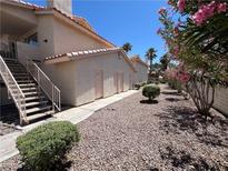 Attractive condo exterior with stairs and desert landscaping on a sunny day at 7948 Calico Vista Blvd # 101, Las Vegas, NV 89128