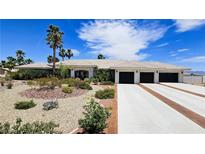 Charming single-story home boasts a three-car garage, desert landscaping, and a tile roof at 8290 Gagnier Blvd, Las Vegas, NV 89113