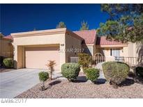 Charming single-story home featuring a red tile roof, well-manicured landscaping, and an attached two-car garage at 9424 Gold Mountain Dr, Las Vegas, NV 89134