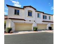 Inviting townhome featuring attached garages and well-maintained landscaping at 1525 Spiced Wine Ave # 14101, Henderson, NV 89074
