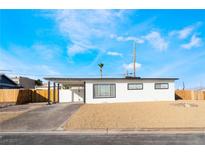 Charming single-story home features a desert landscape, covered carport, and a freshly painted exterior at 2 Utah Way, Henderson, NV 89015