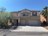 Charming two-story home featuring a two-car garage, neutral stucco and well-kept landscaping under a clear blue sky at 2261 Dalton Ridge Ct, North Las Vegas, NV 89031